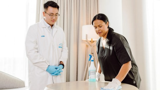 Ecolab expert coaching housekeeper on cleaning best practices.